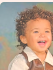 An Wishful Portraits portrait, a laughing young boy in a classic studio portrait